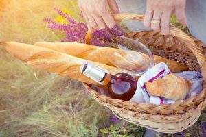 basket with pastries and wine for a budget picnic date