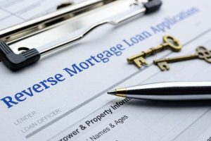  Close up of reverse mortgage loan application with pen and two brass keys. 