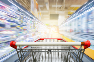 Concept of shopping cart moving at high speed with store aisles blurring to its sides