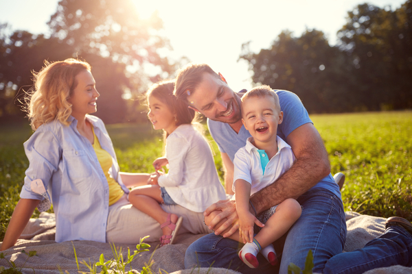 young family enjoying frugal picnic